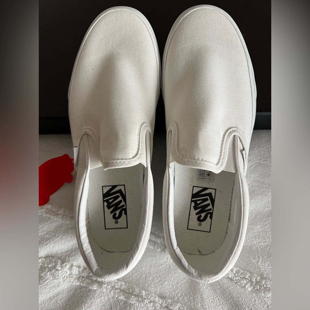 Vans classic white slip on shoes.